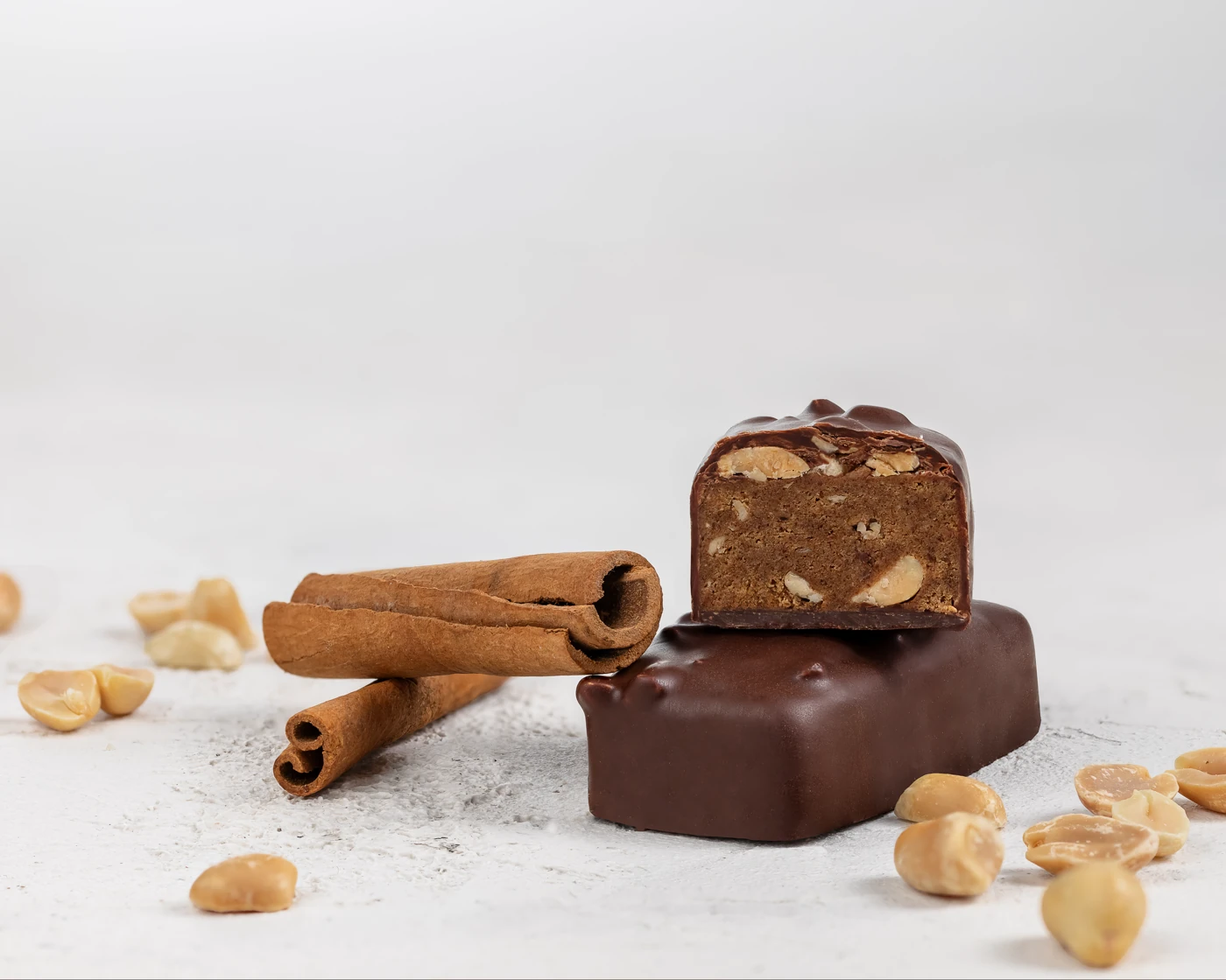 MojoBite salty peanut chocolate protein bar with cinnamon sticks and peanuts