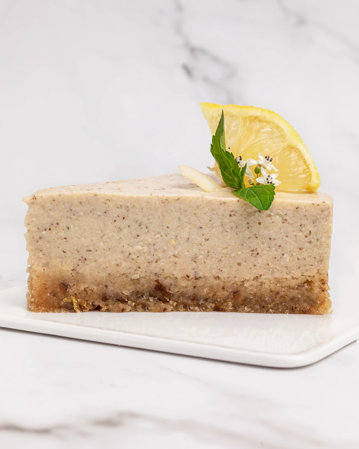 Lemon cake slice - cross-section showing layers with mint garnish