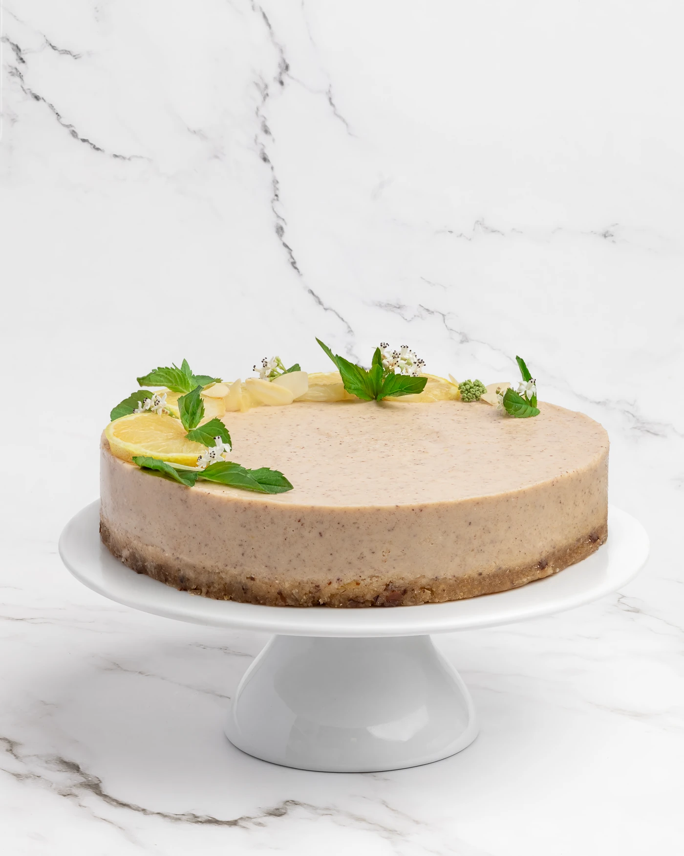 Whole lemon mint cake - decorated with citrus slices, mint, and edible flowers