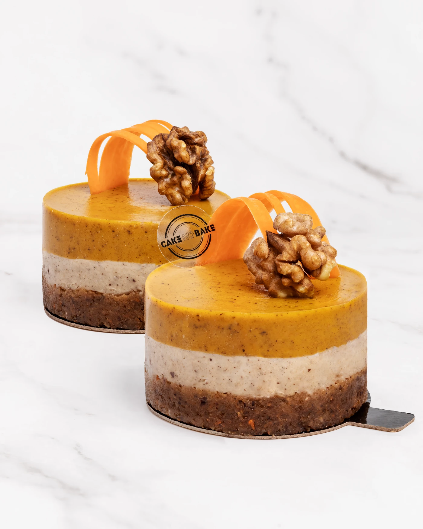 Orange and walnut cake with decorative orange curl - distinct layered composition