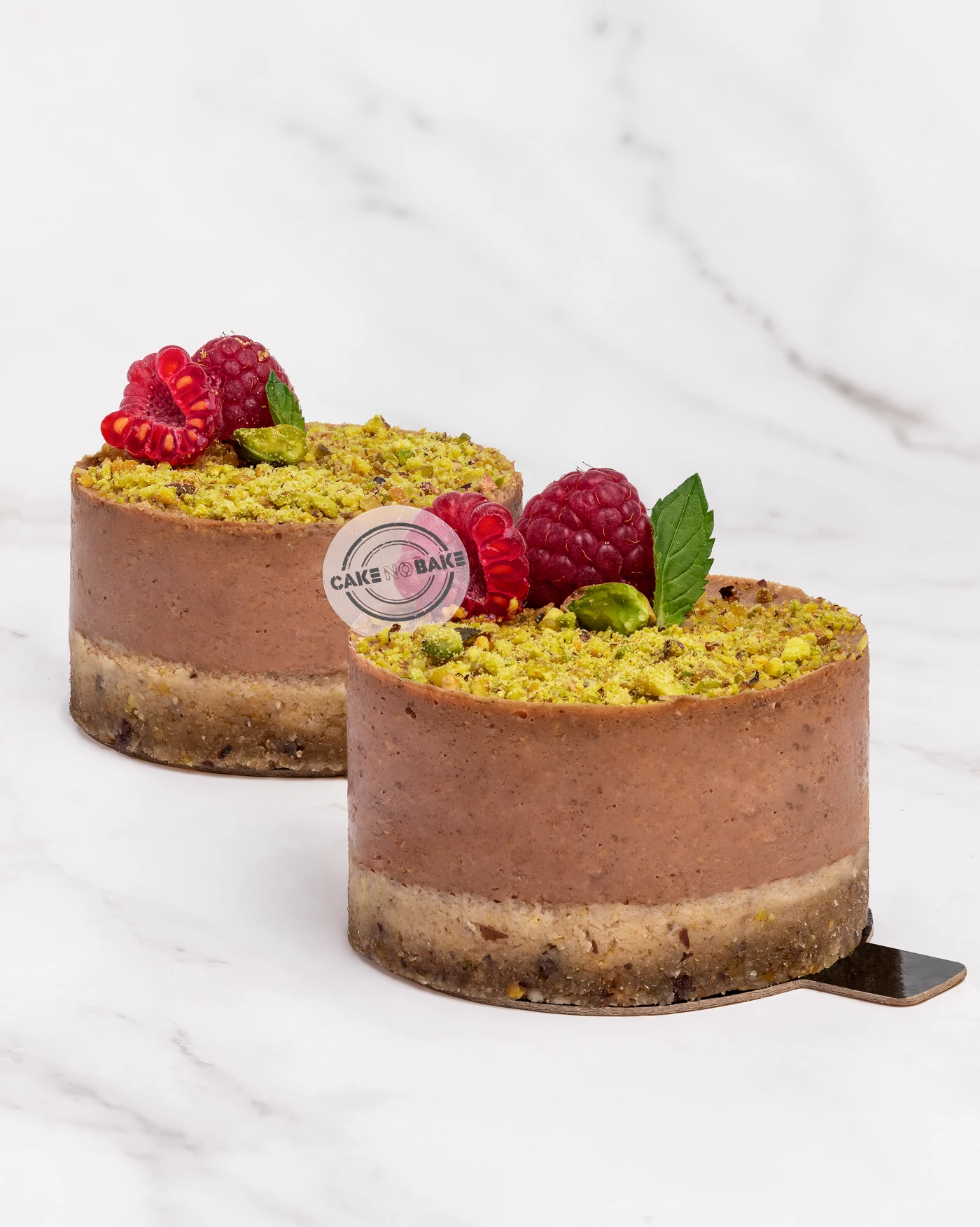 Pistachio raspberry cake - vivid green crust with fresh raspberry garnish
