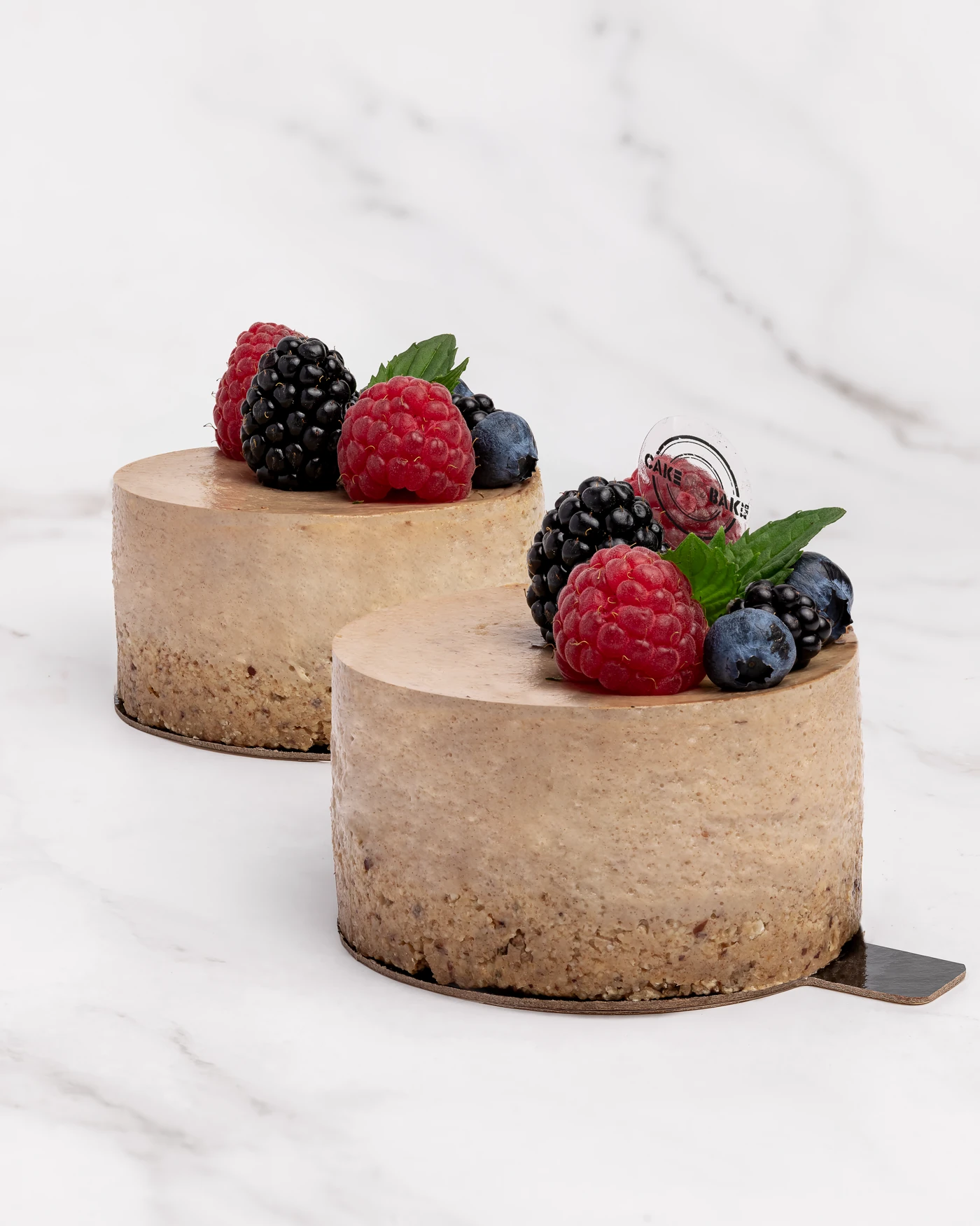 Raspberry blueberry mini cake - individual portion with fresh berry garnish