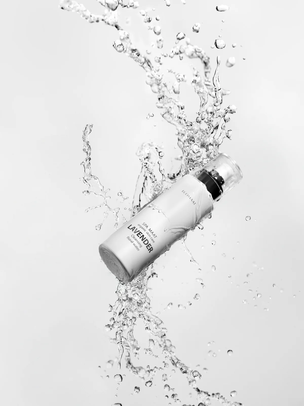ECOMAAT Lavender floral water bottle captured in dynamic water splash