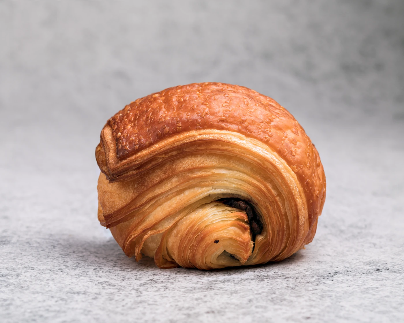 Croissant close-up - golden layers of buttery lamination