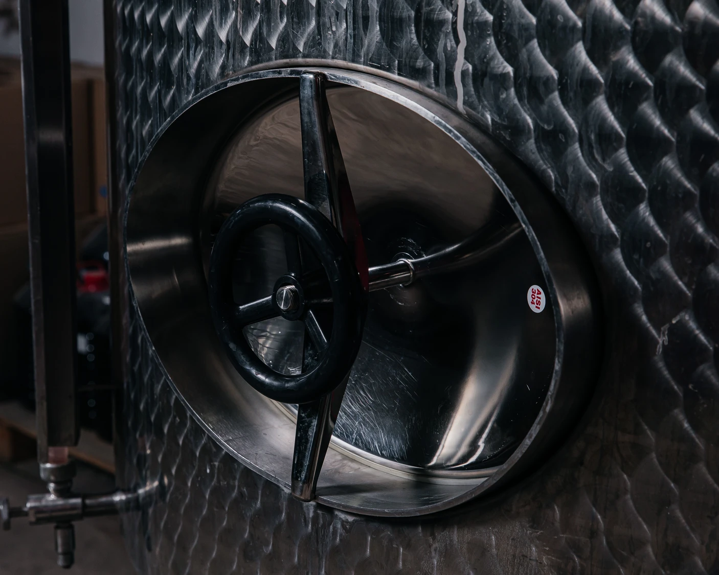 Modern stainless steel fermentation tank at Villa Vinifera Winery for Bulgarian wine production.