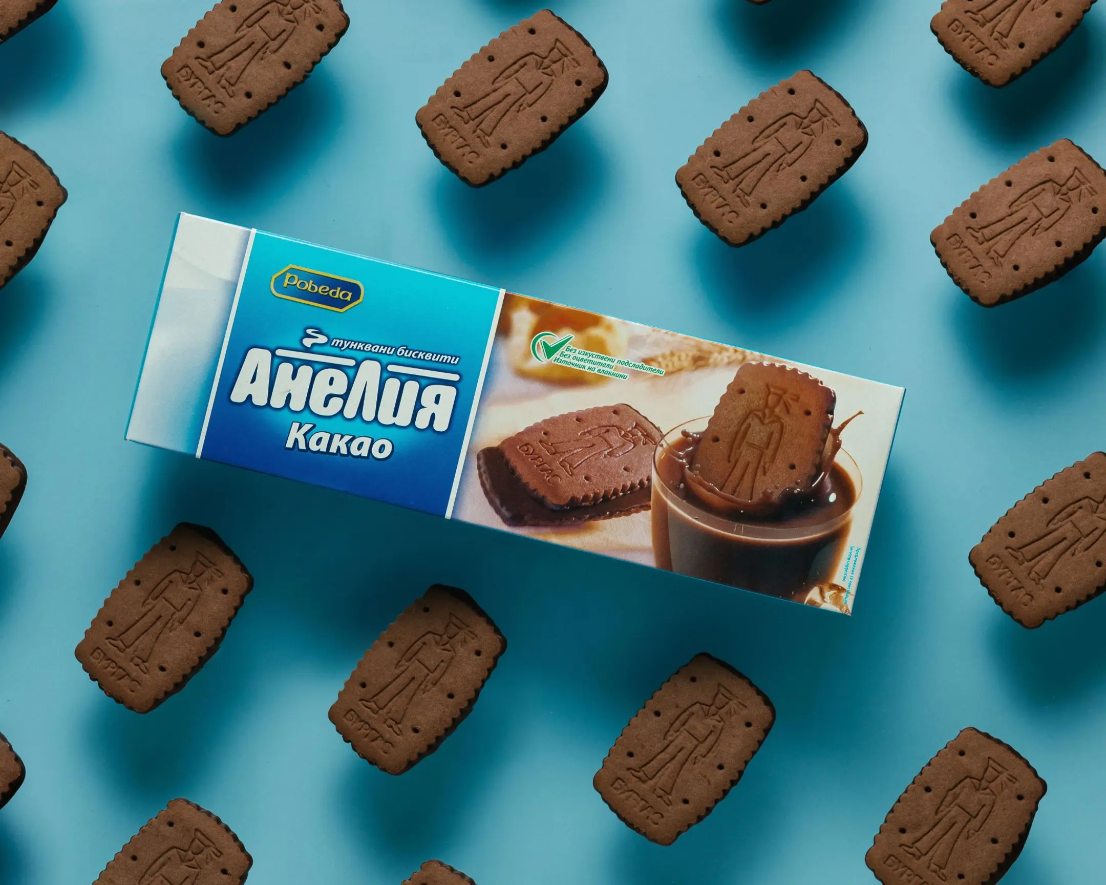 Pobeda Anelia Cacao chocolate biscuit box with floating Burgas cookies on blue, for product photography using glass.