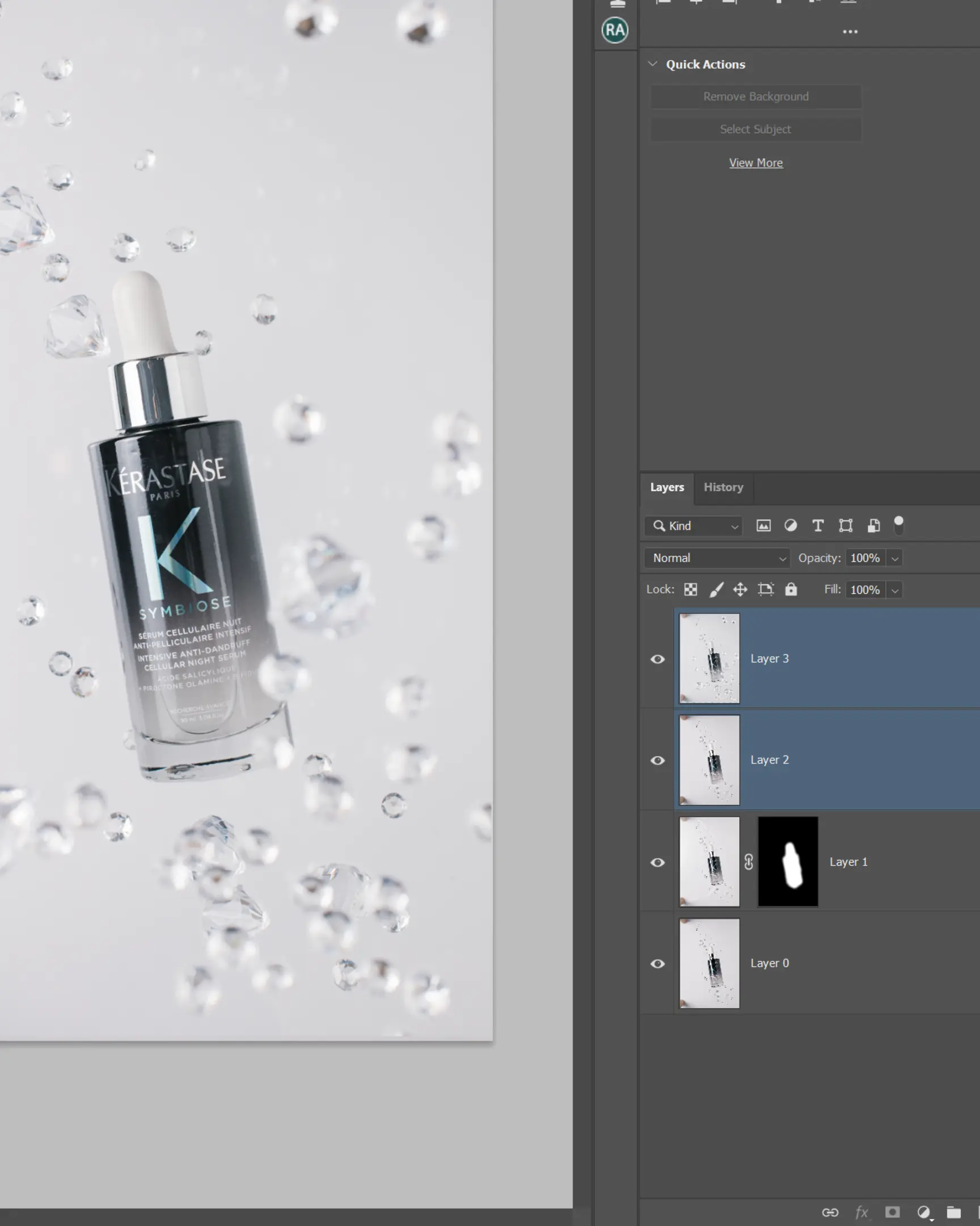 Kérastase Symbiose anti-dandruff serum bottle with suspended droplets, demonstrating glass product photography.