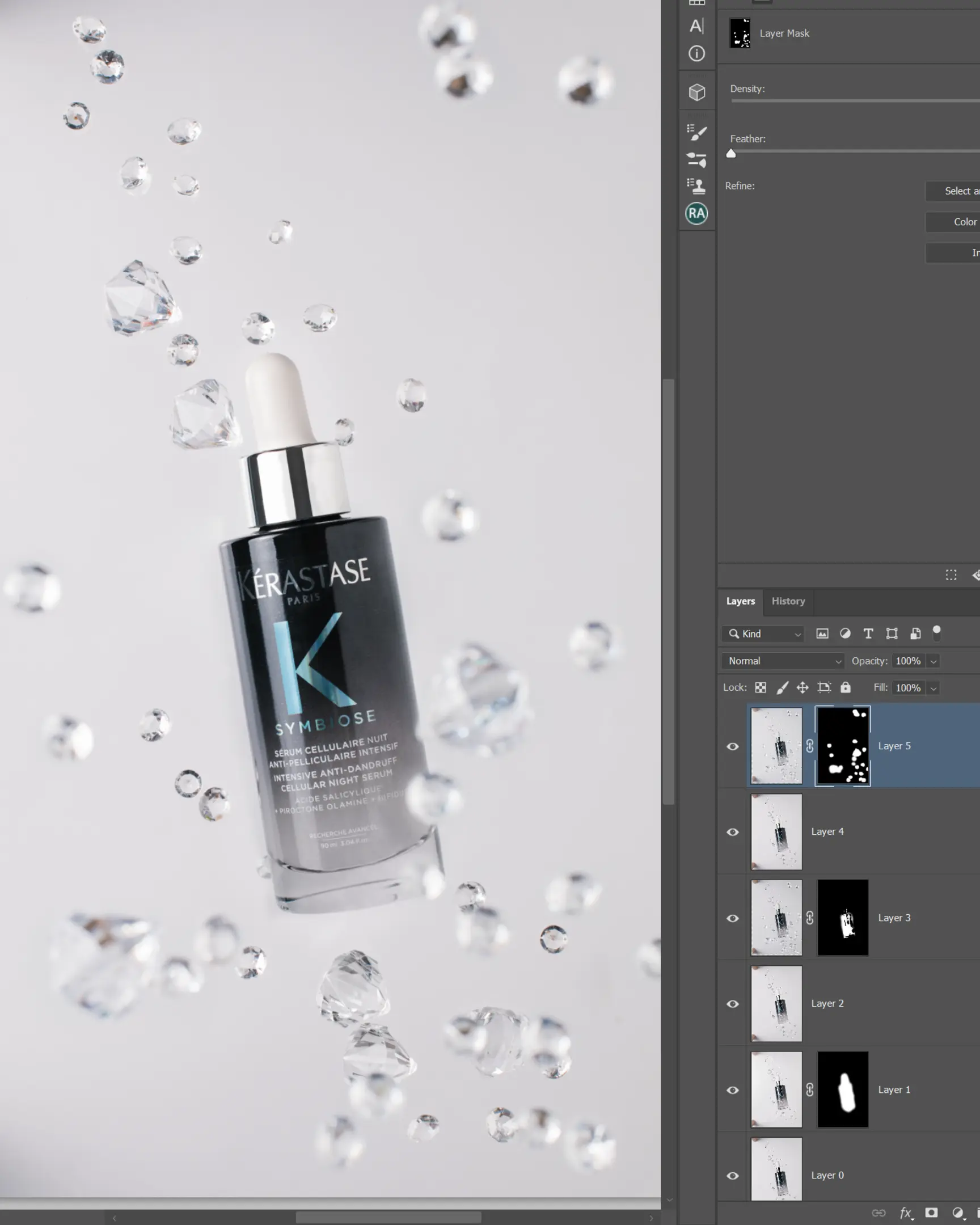 Kérastase Symbiose serum with suspended droplets & clear gems on white, showing glass technique for product photography.