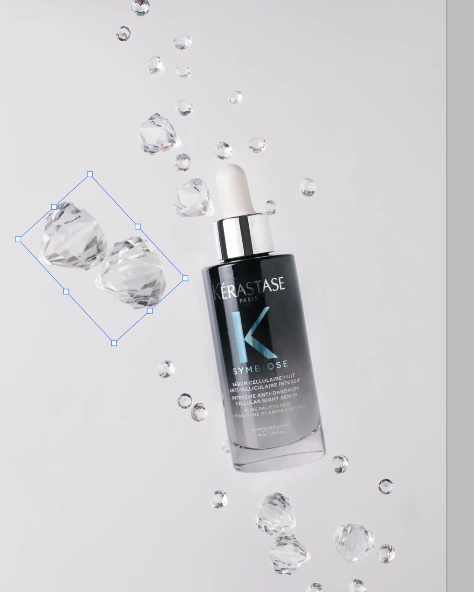 Kérastase Symbiose Night Serum bottle with suspended crystals on white, showcasing floating effect for product photography.