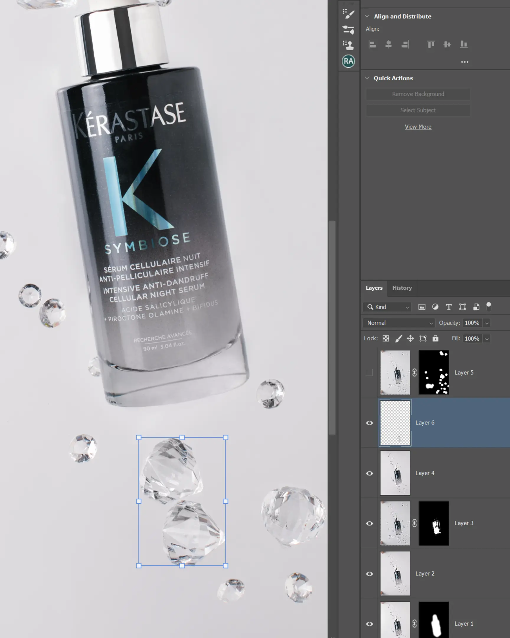 Kerastase Symbiose Night Serum bottle & suspended faceted gems on white, showing product photography editing.