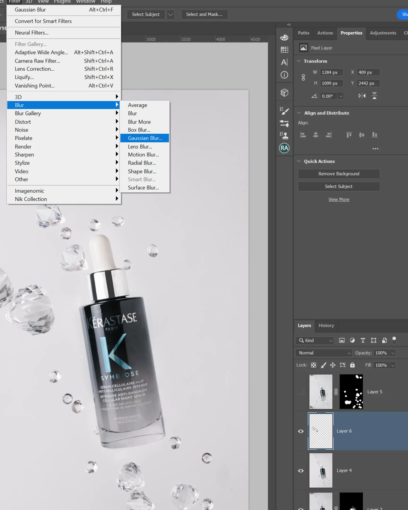 Photoshop's Gaussian Blur filter on Kérastase Symbiose serum with suspended droplets for product photography effects.
