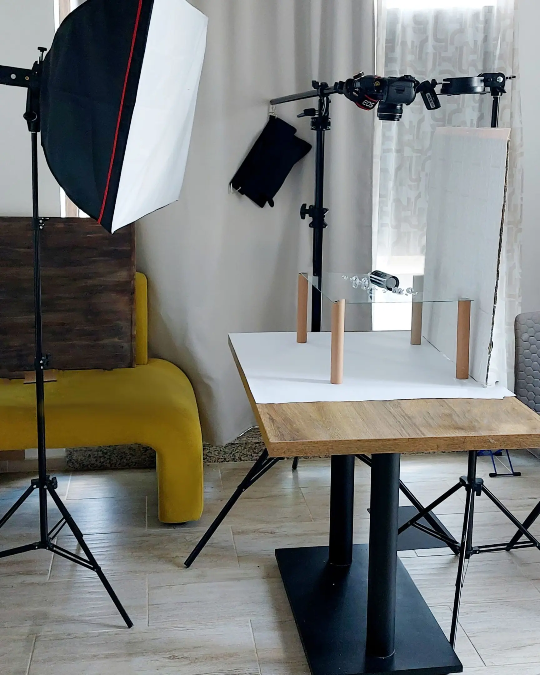 Product photography studio setup with softbox, Canon EOS camera, and elevated glass for floating & suspended droplet effects.