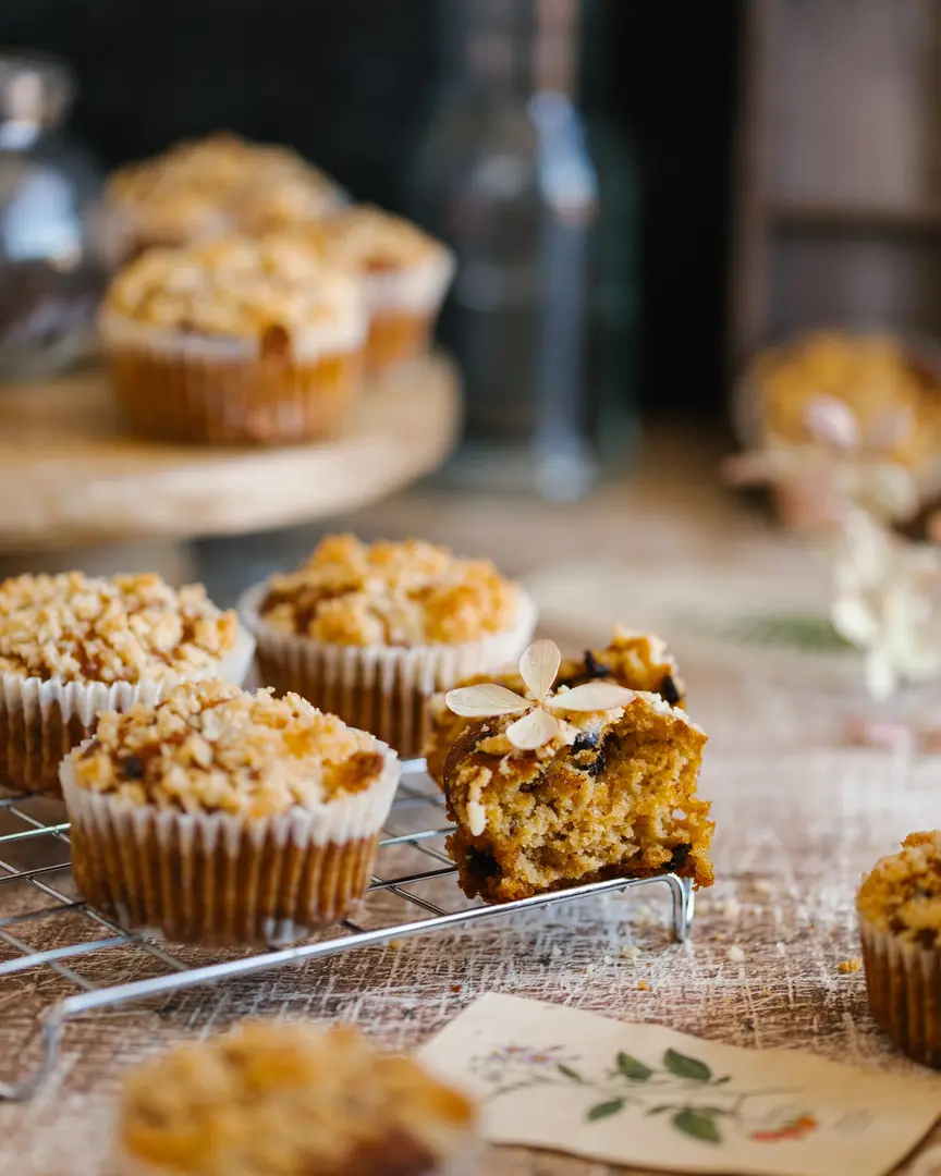 Freshly baked pumpkin muffins with crumble and chocolate drops, one cut open, highlighting the easy fall recipe.