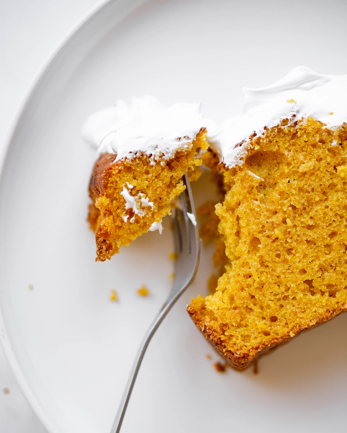 Pumpkin bread slice with mascarpone cream, fork taking a bite. Simple one-bowl recipe.