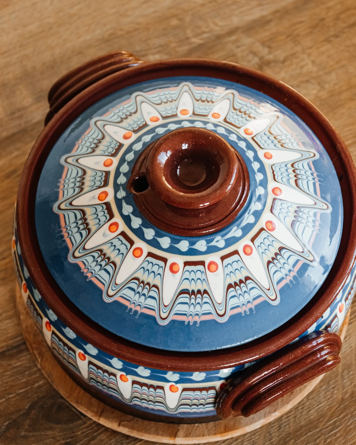 Ornate blue and brown clay pot for baking traditional potato babka or kugelis.