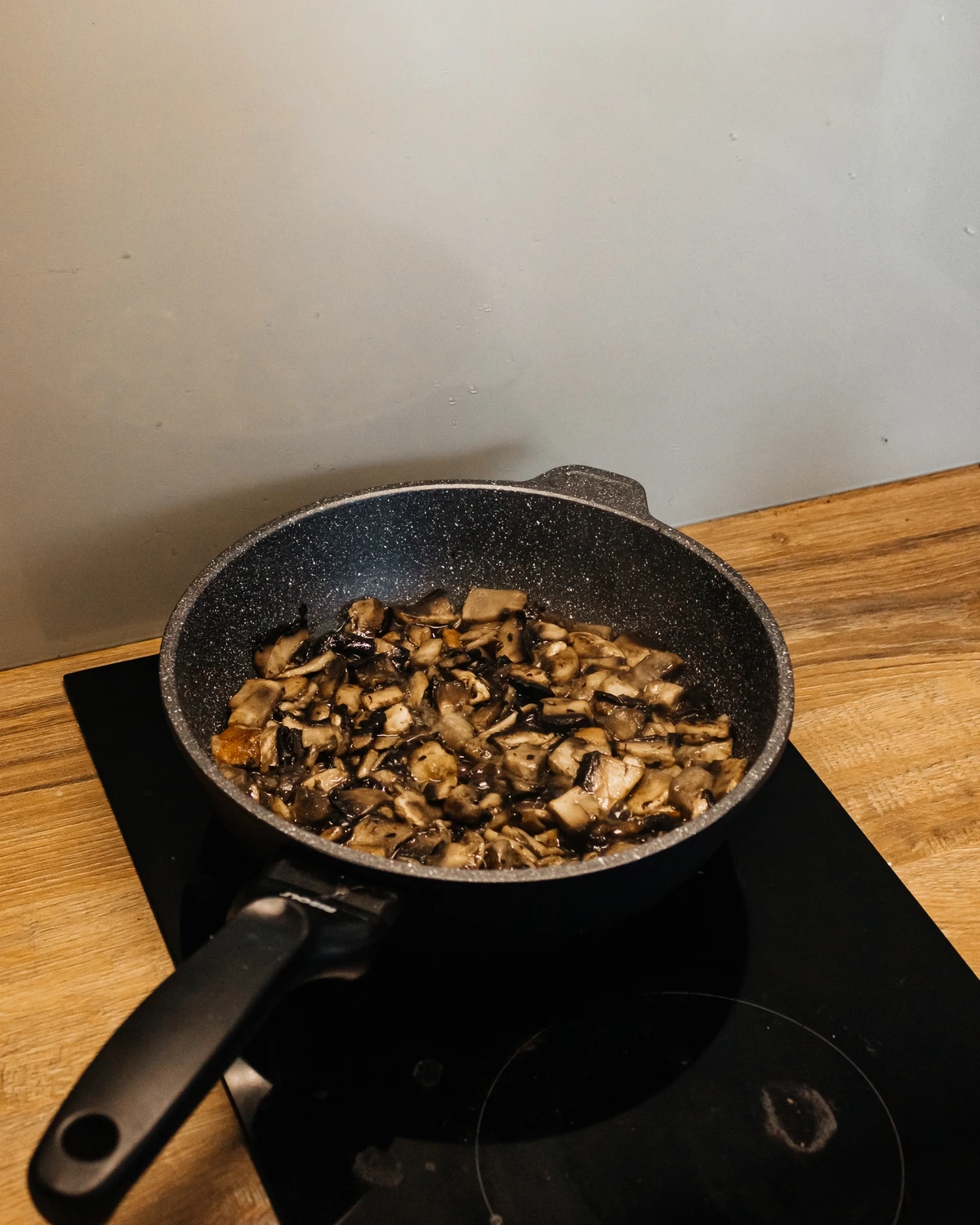 Fried Portobello or Boletus mushrooms in a pan for potato babka/kugel filling.