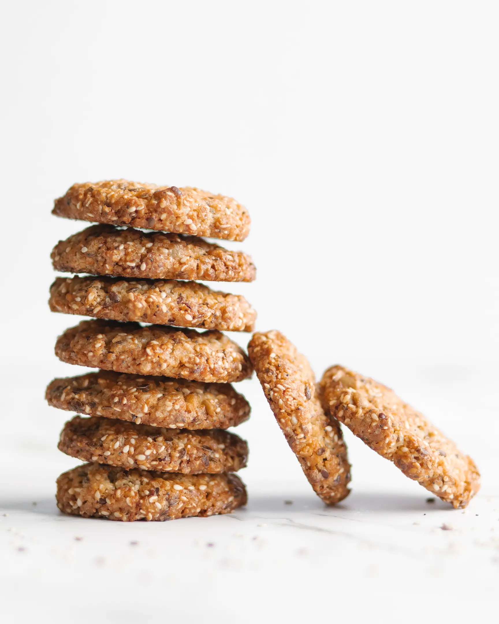 Delicious mixed seed cookies, stacked, featuring sesame, poppy, and sunflower seeds from the recipe.