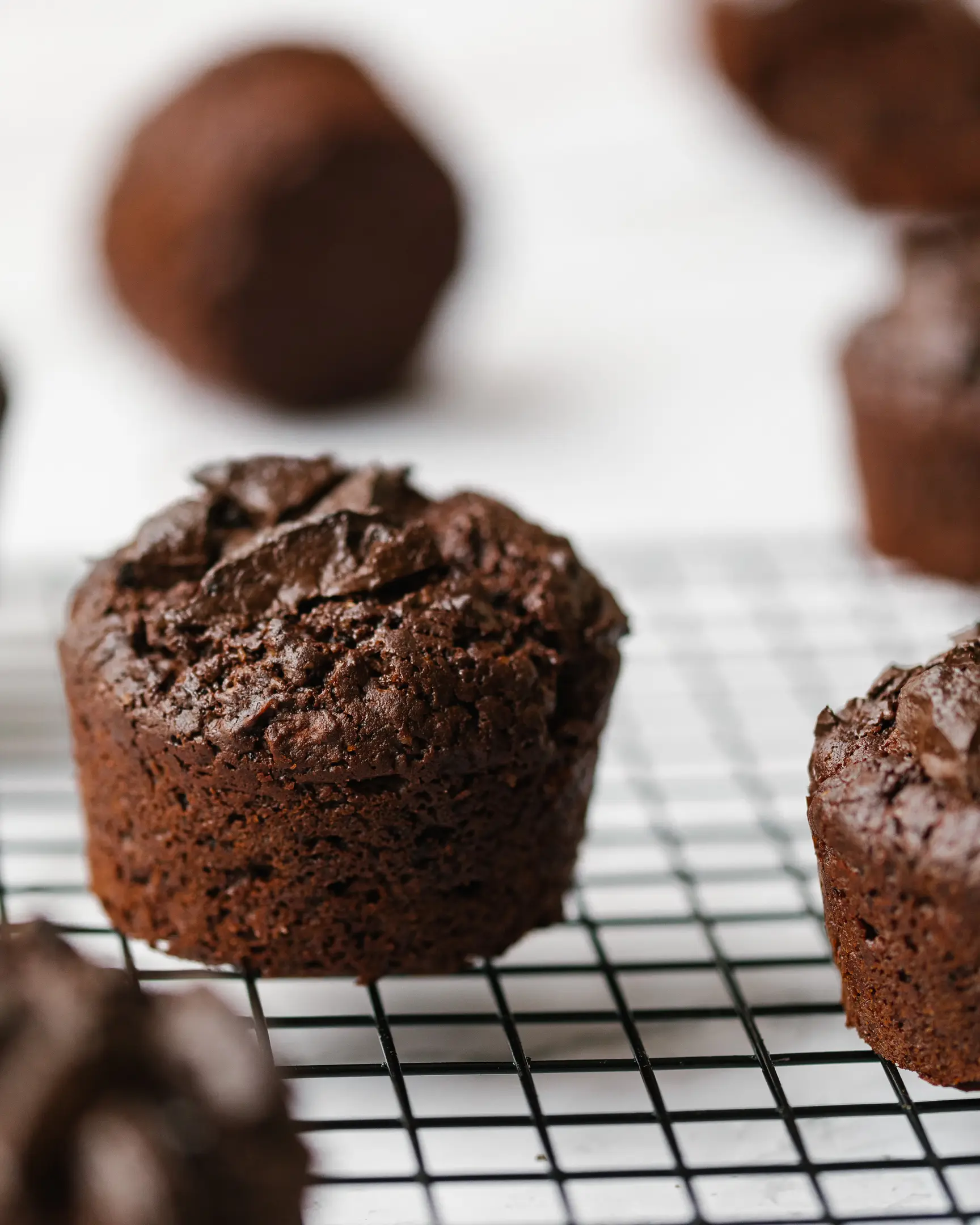 Freshly baked chocolate-apple cupcakes on a cooling rack, highlighting the delicious apple flavor and moist texture.