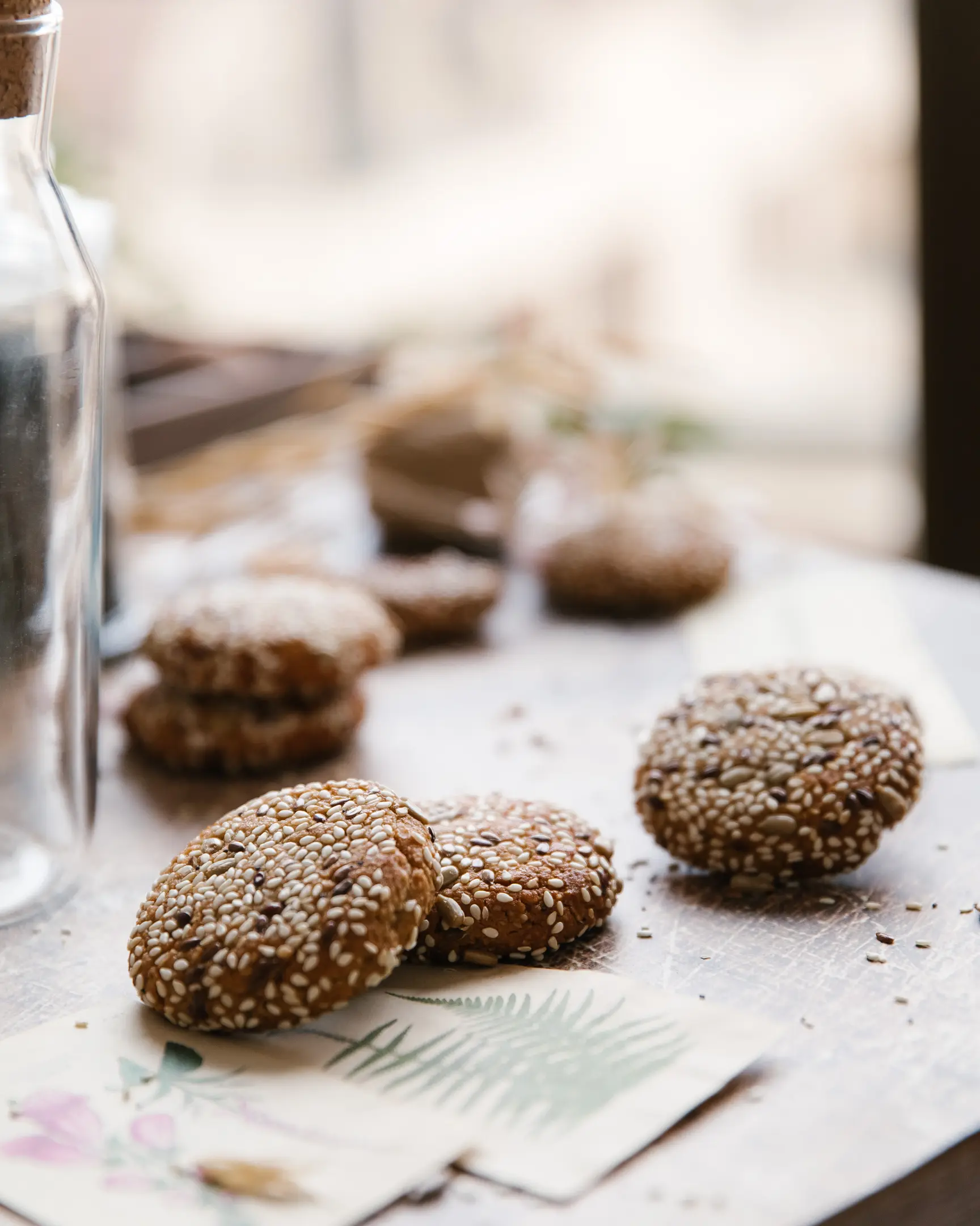 Golden brown vegan tahini cookies with a crispy sesame, flax, and sunflower seed coating.