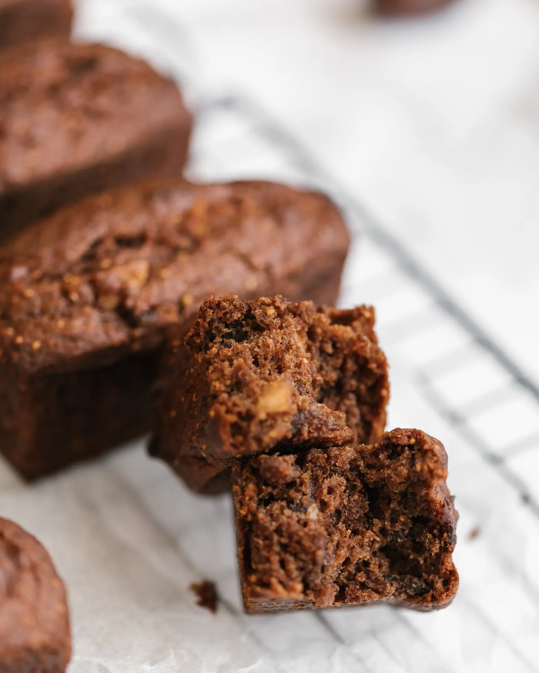 Chocolate slice with dark cake, vanilla mascarpone cream, nutty chocolate glaze, and cacao dust.