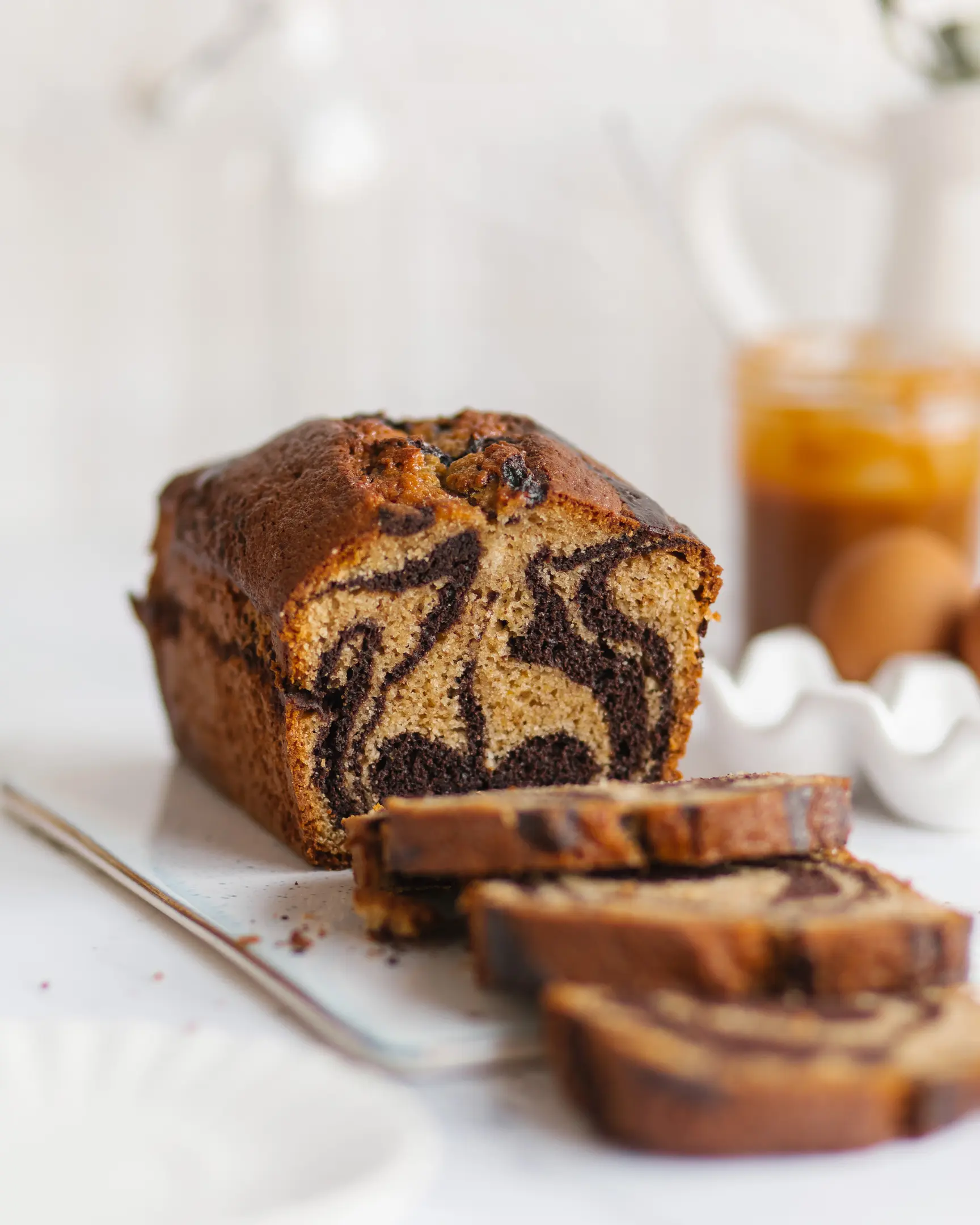 Moist marble tangerine banana quick bread, sliced to show rich chocolate and light dough swirls.