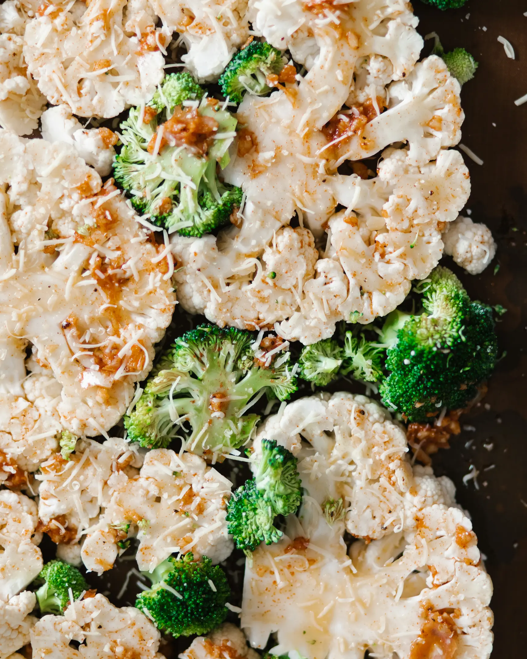 Baked vegetables recipe: cauliflower & broccoli with garlic, smoked paprika marinade & grated Parmigiano-Reggiano cheese.