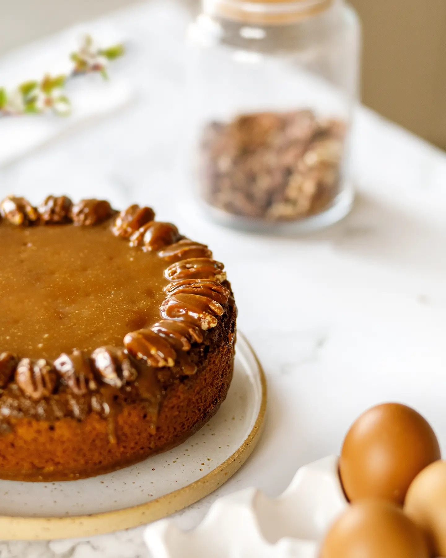 Perfectly sweet caramel pecan cake with sticky pecan topping. Eggs & pecans visible for an easy dessert recipe.