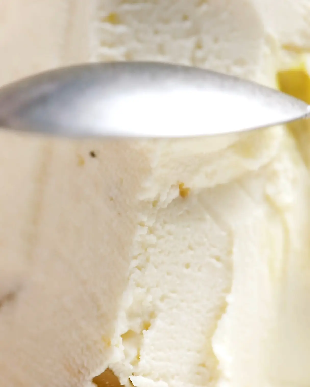 Spoon revealing the creamy texture of Cottage Cheese Easter Dessert with orange zest.