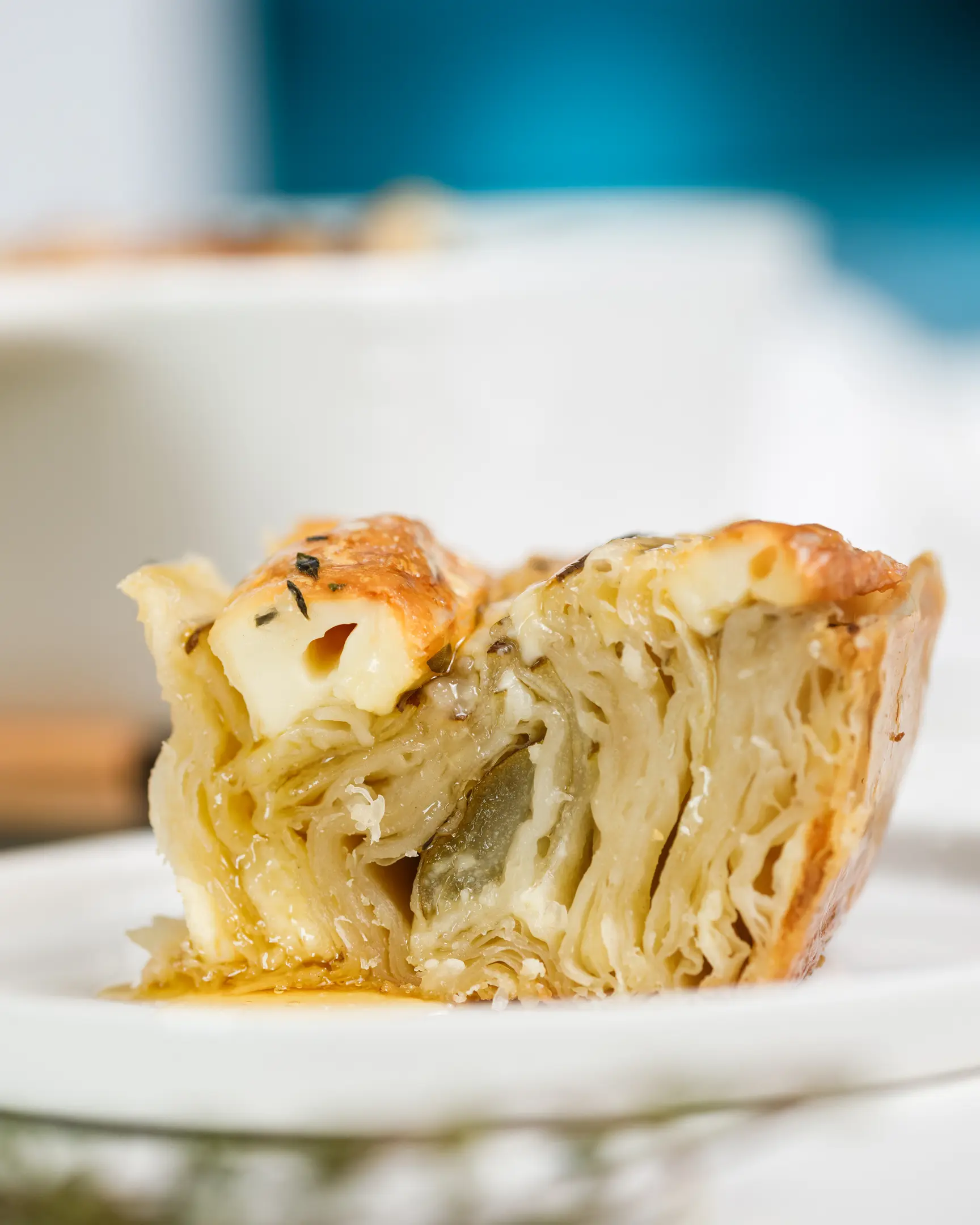 Golden baked filo pastry tart slice with layers of Brie cheese & pear, drizzled with honey & fresh thyme.