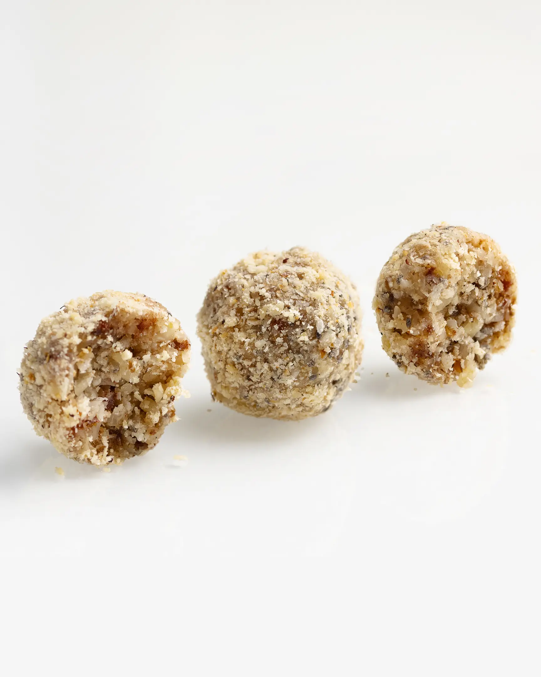 Three healthy, natural Almond-Apricot Candies coated in finely chopped nuts. A no-added-sugar snack providing sustained energy.