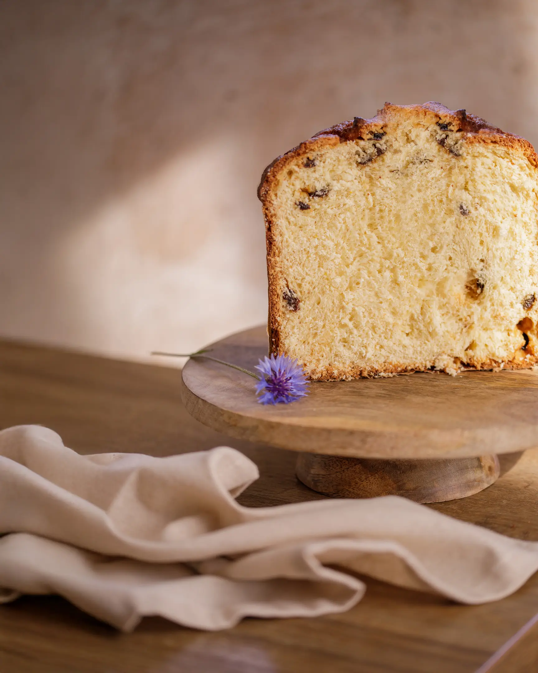 Slice of kulich sweet bread with candied fruit, showcasing its moist, rich crumb and enhanced texture.